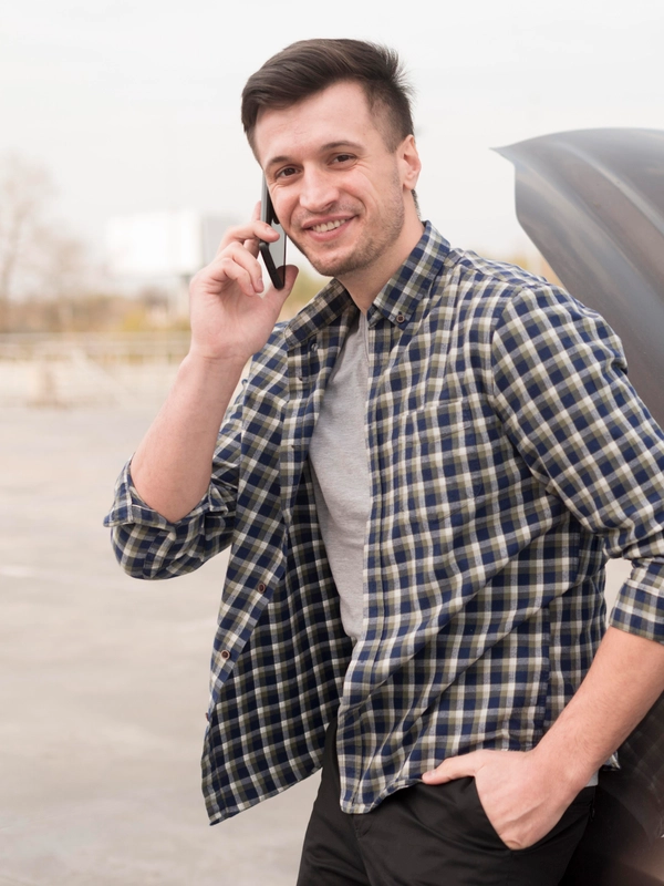 Man with broken car talking phone