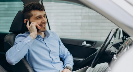 Man working laptop inside his car