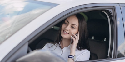 Woman talking phone while driving