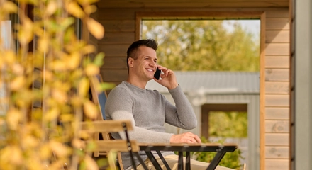 Man talking smartphone sitting open terrace