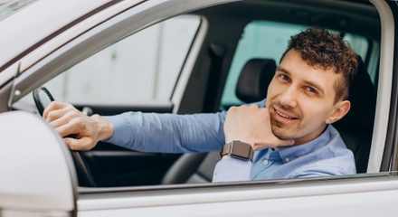 Man sitting his car looking through window