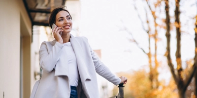Business woman talking phone outside