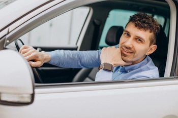 Man sitting his car looking through window