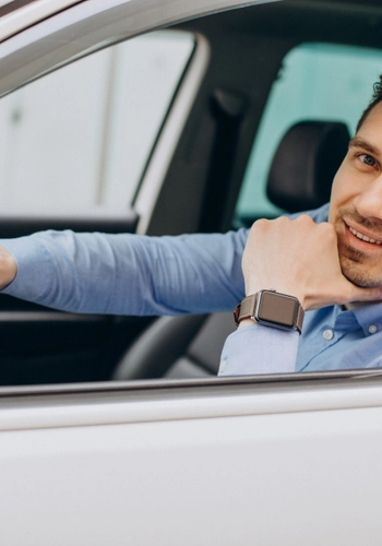 Man sitting his car looking through window