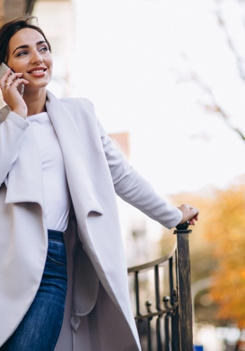 Business woman talking phone outside