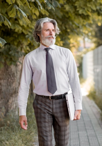 Front view senior male walking outdoors
