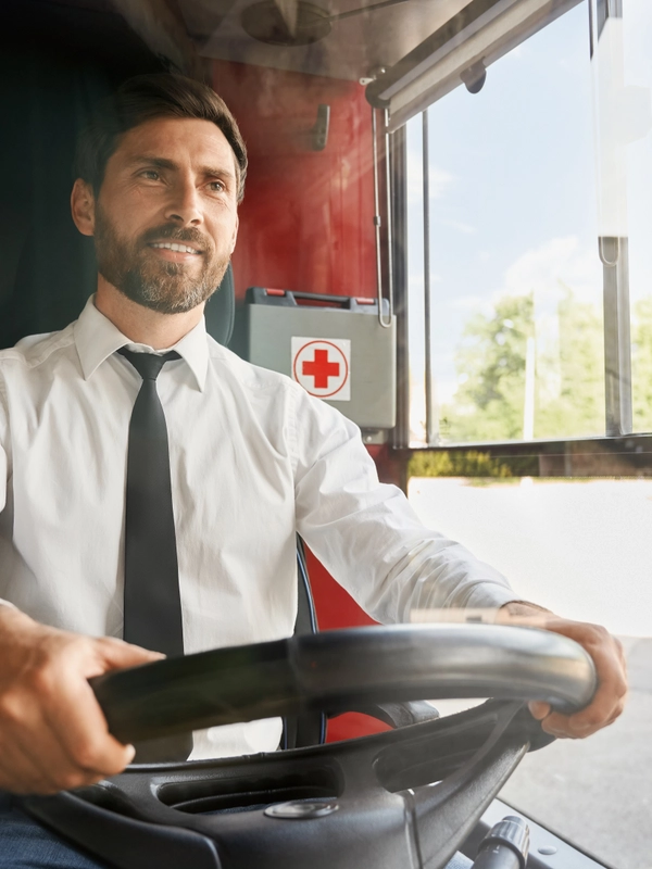 Handsome professional bus driver steering wheel sitting cabin work front view smiling