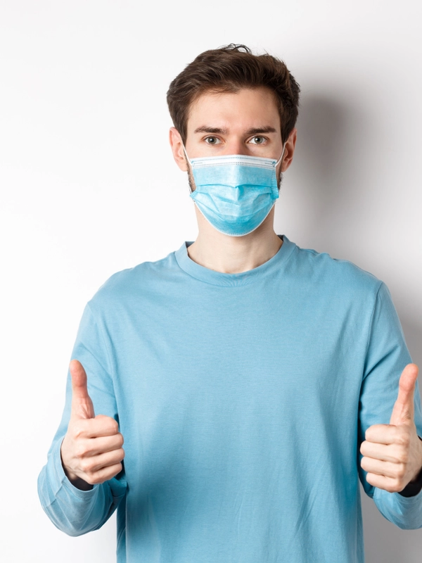 Covid pandemic social distancing concept young man casual clothes medical mask showing th