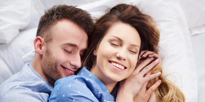 Young couple hugging bed morning