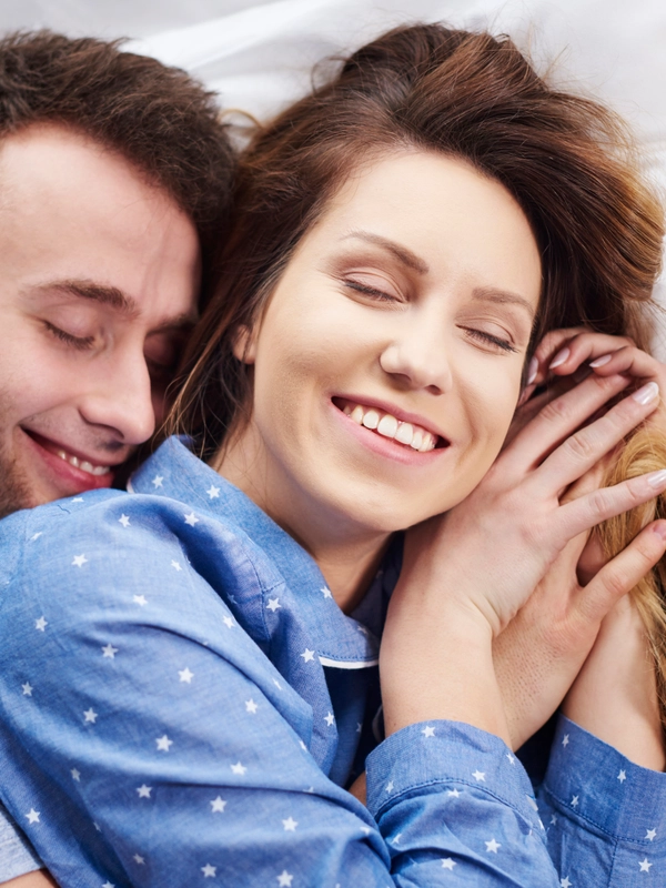 Young couple hugging bed morning