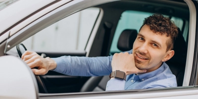 Man sitting his car looking through window