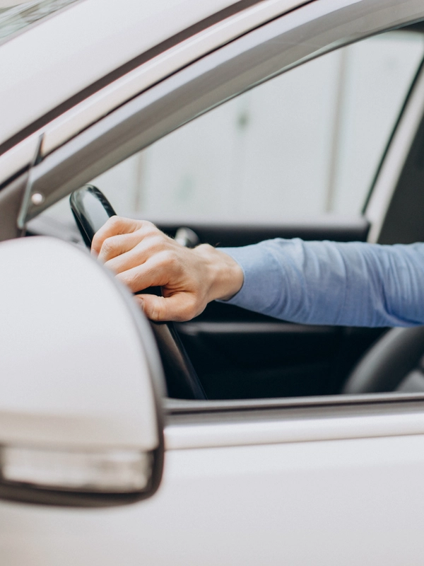 Man sitting his car looking through window