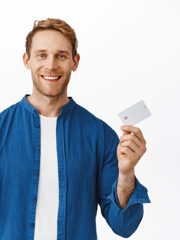 Smiling happy man showing mobile phone blank screen bank credit card recommending smartphone application online shopping app standing white background