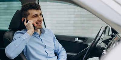 Man working laptop inside his car