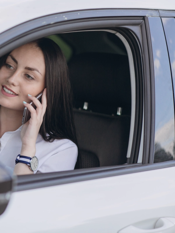 Woman talking phone while driving