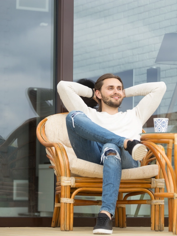 Smiling relaxed man enjoying pleasant morning sitting terrace outdoor