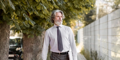 Front view senior male walking outdoors