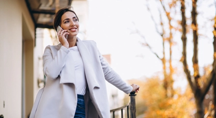 Business woman talking phone outside