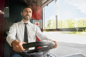 Handsome professional bus driver steering wheel sitting cabin work front view smiling