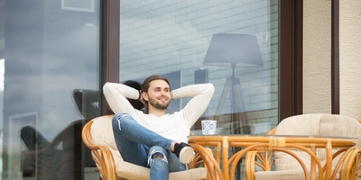 Smiling relaxed man enjoying pleasant morning sitting terrace outdoor